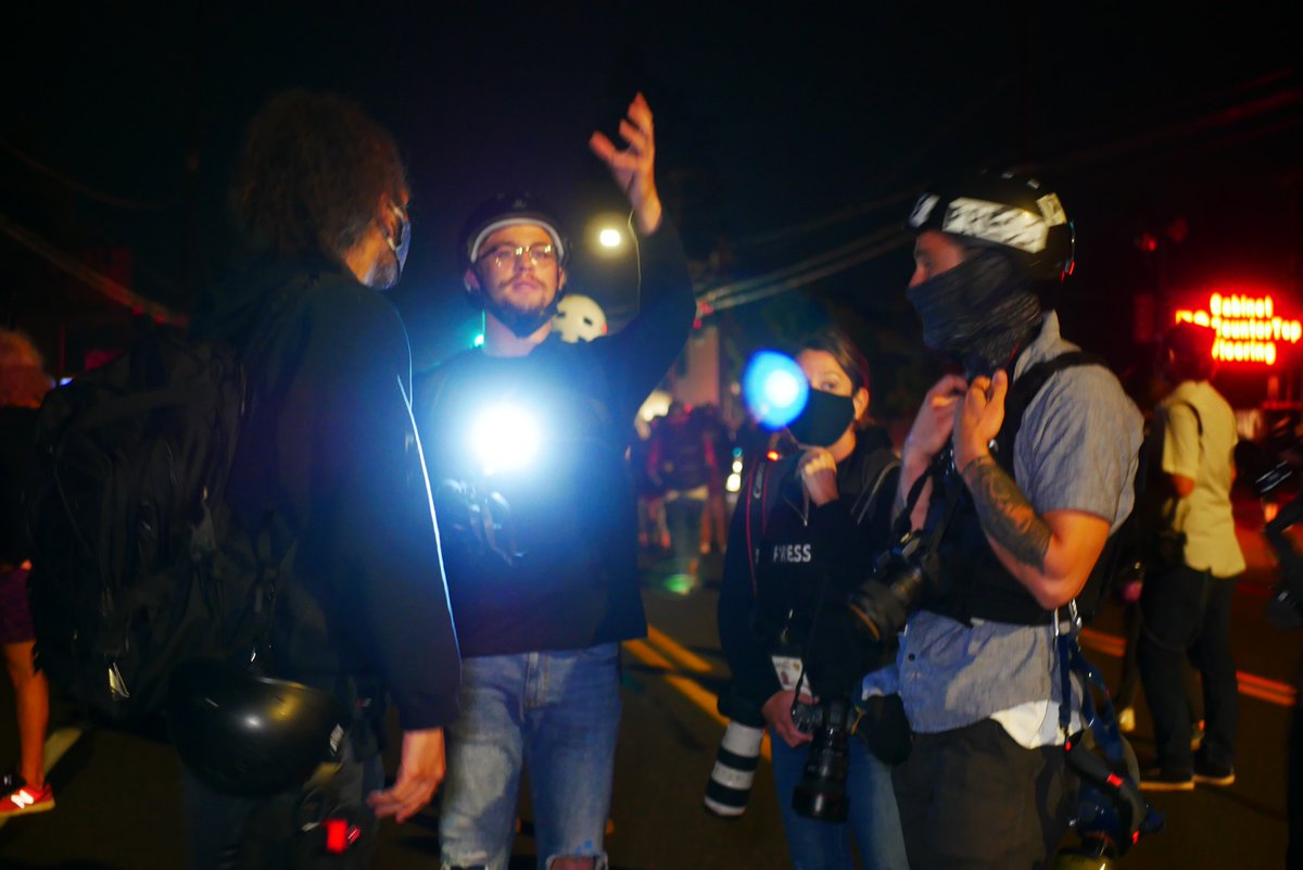 9/5 2108-2111 Protesters discuss whether to advance despite LRAD, eventually they move forward, chanting and headed West.  #pdxprotest  #BLM  #portland  #blacklivesmatter    #portlandprotest  #defendpdx  #blmprotest