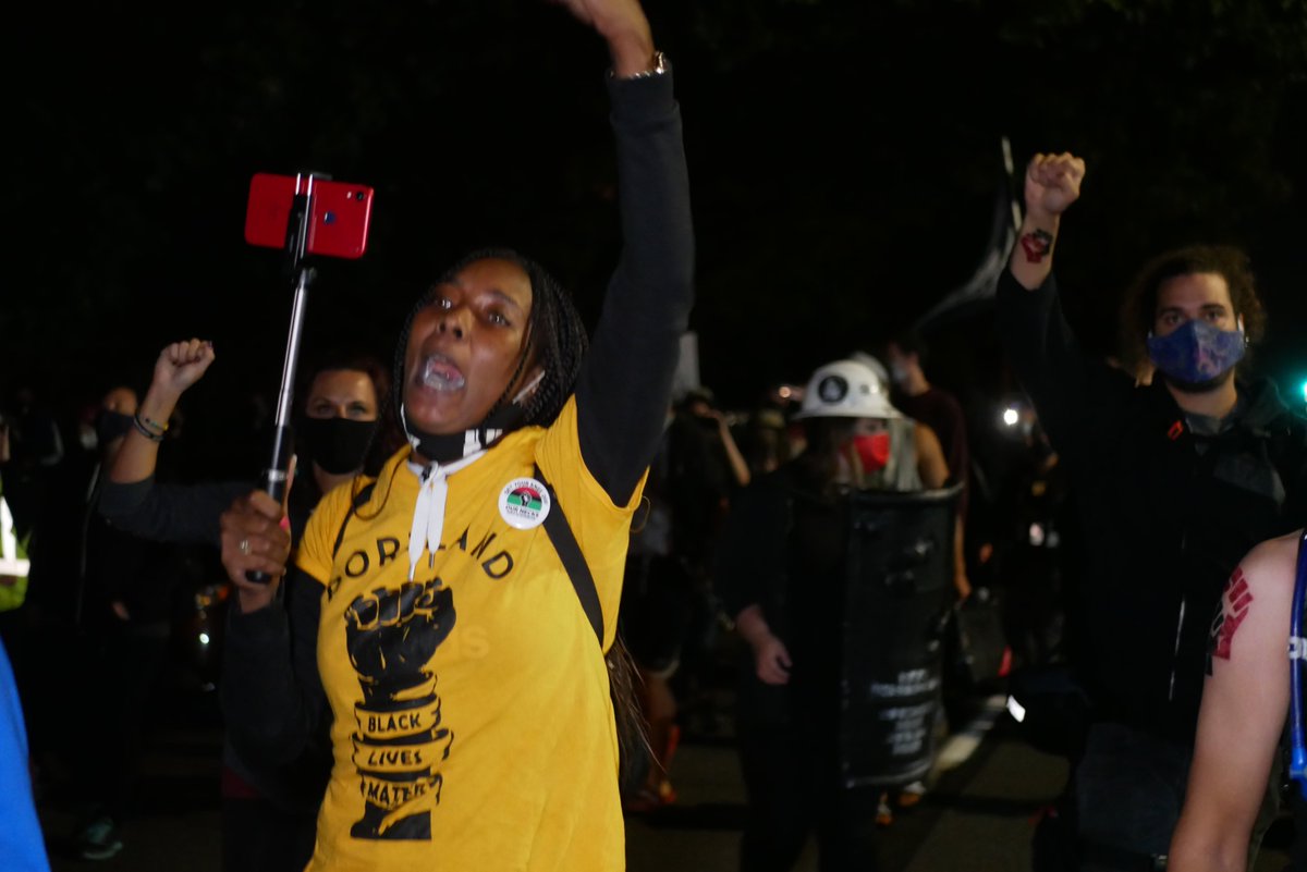 9/5 2108-2111 Protesters discuss whether to advance despite LRAD, eventually they move forward, chanting and headed West.  #pdxprotest  #BLM  #portland  #blacklivesmatter    #portlandprotest  #defendpdx  #blmprotest