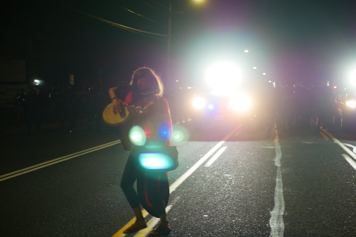 9/5 2113-2114 A protester drums in front of the police line, as a shield wall assembles. Press flock to the wall to shoot photos of the protesters' line.  #pdxprotest  #BLM  #portland  #blacklivesmatter    #portlandprotest  #defendpdx  #blmprotest