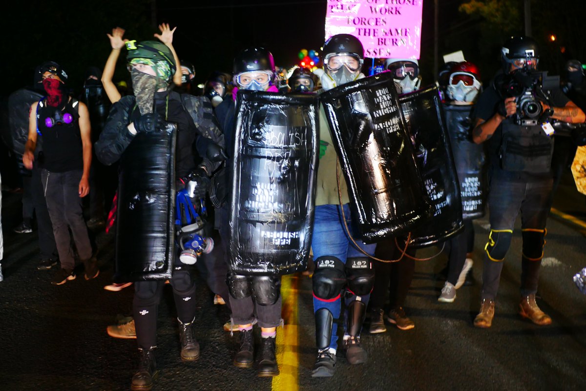 9/5 2113-2114 A protester drums in front of the police line, as a shield wall assembles. Press flock to the wall to shoot photos of the protesters' line.  #pdxprotest  #BLM  #portland  #blacklivesmatter    #portlandprotest  #defendpdx  #blmprotest