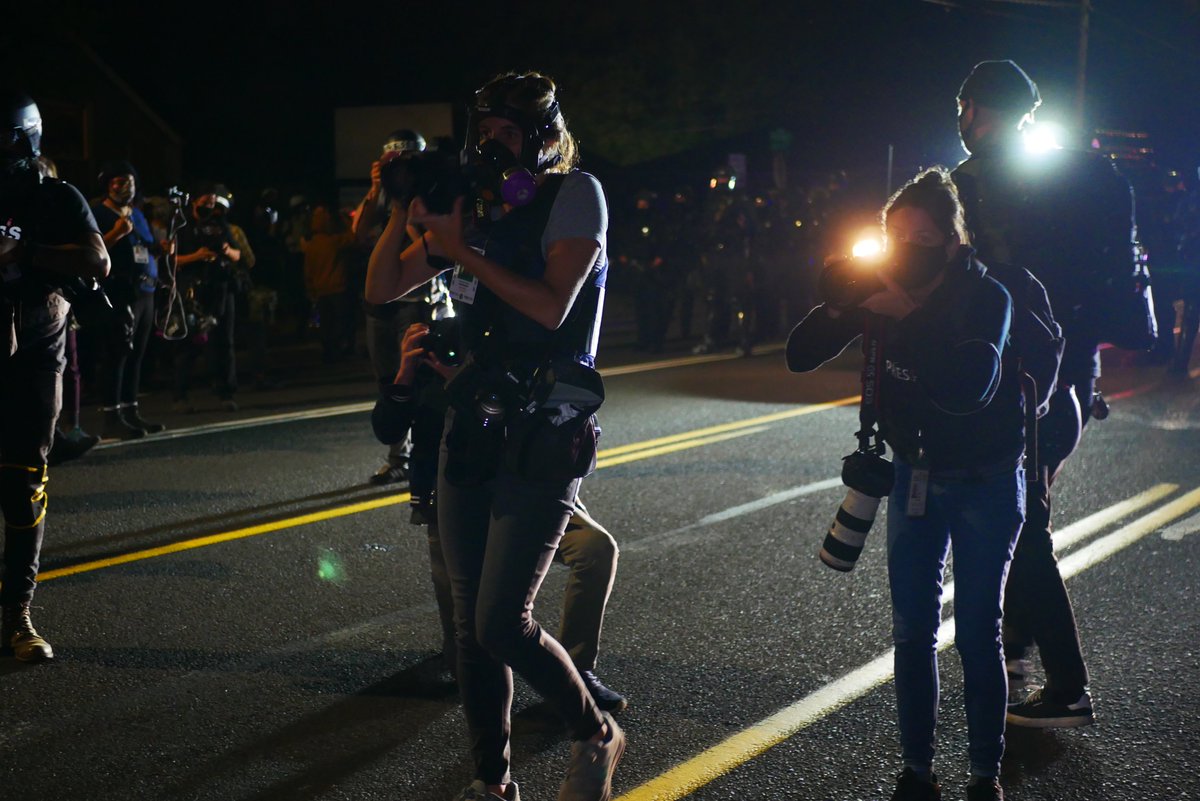 9/5 2113-2114 A protester drums in front of the police line, as a shield wall assembles. Press flock to the wall to shoot photos of the protesters' line.  #pdxprotest  #BLM  #portland  #blacklivesmatter    #portlandprotest  #defendpdx  #blmprotest