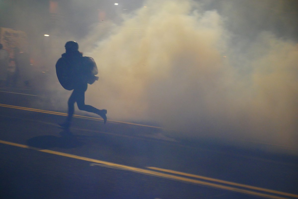 9/5 2122-2122 A protester kicks back a teargas canister before turning to run. More gas is fired as they retreat.  #pdxprotest  #BLM  #portland  #blacklivesmatter    #portlandprotest  #defendpdx  #BLMprotests video:  https://twitter.com/BaghdadBrian/status/1302464922886914050