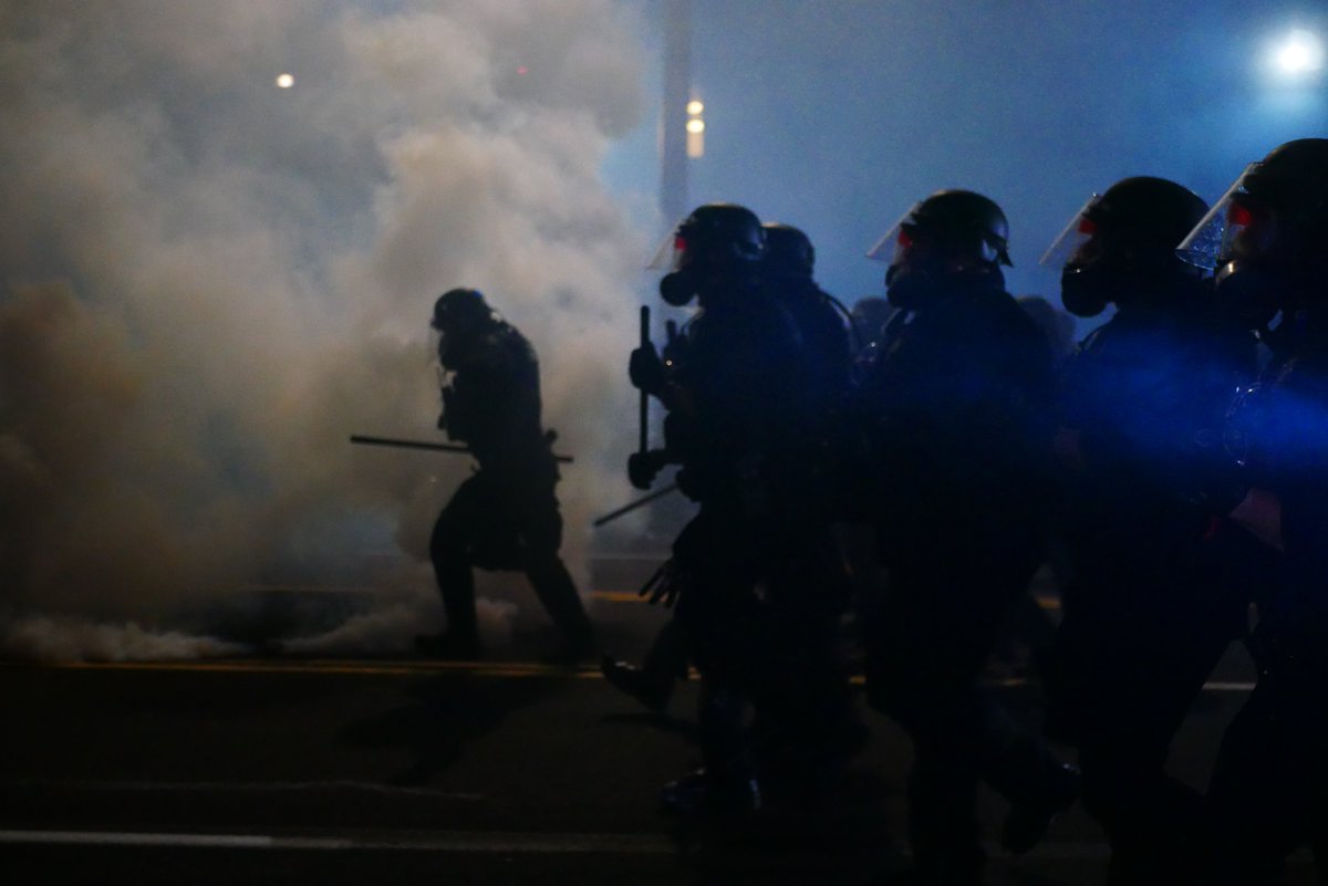 2122-2123 An officer scans the crowd before additional smoke is thrown and the advance continues. #pdxprotest  #BLM  #portland  #blacklivesmatter    #portlandprotest  #defendpdx  #BLMprotests video:  https://twitter.com/BaghdadBrian/status/1302464922886914050