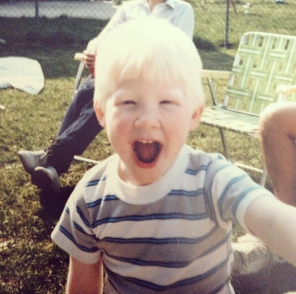 Photo of me as a toddler smiling.