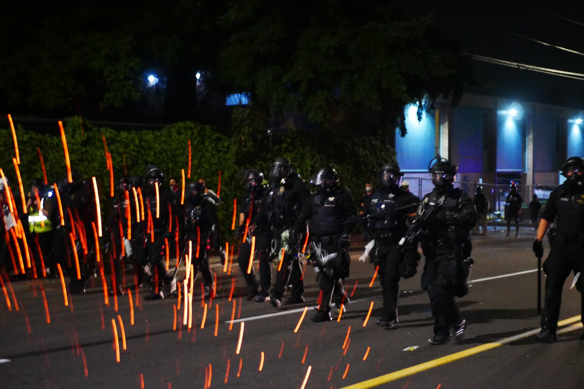 9/5 2249-2250 An officer lobs a gas or smoke canister at this reporter. After this officers continue to advance toward the burning barricades.  #pdxprotest  #BLM  #portland  #blacklivesmatter    #portlandprotest  #defendpdx  #BLMprotestsvideo:  https://twitter.com/BaghdadBrian/status/1302502117312139271