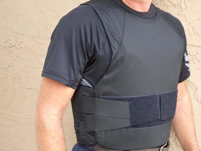 This is a concealable ballistic vest.They always use velcro straps, and they don't leave your belly exposed.Hard plastic quick-release buckles become shrapnel if hit by bullets.