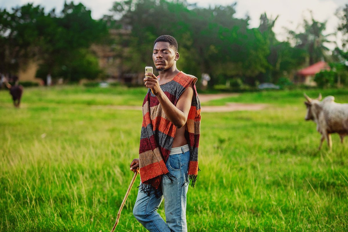 KaiOStech's tweet image. We’re one of the winners of the @WSISprocess Forum photo contest! We teamed with #Adtags to capture photos of people using #SmartFeaturePhones. See this winning photo from rural Nigeria, showing a man using a #KaiOS device.