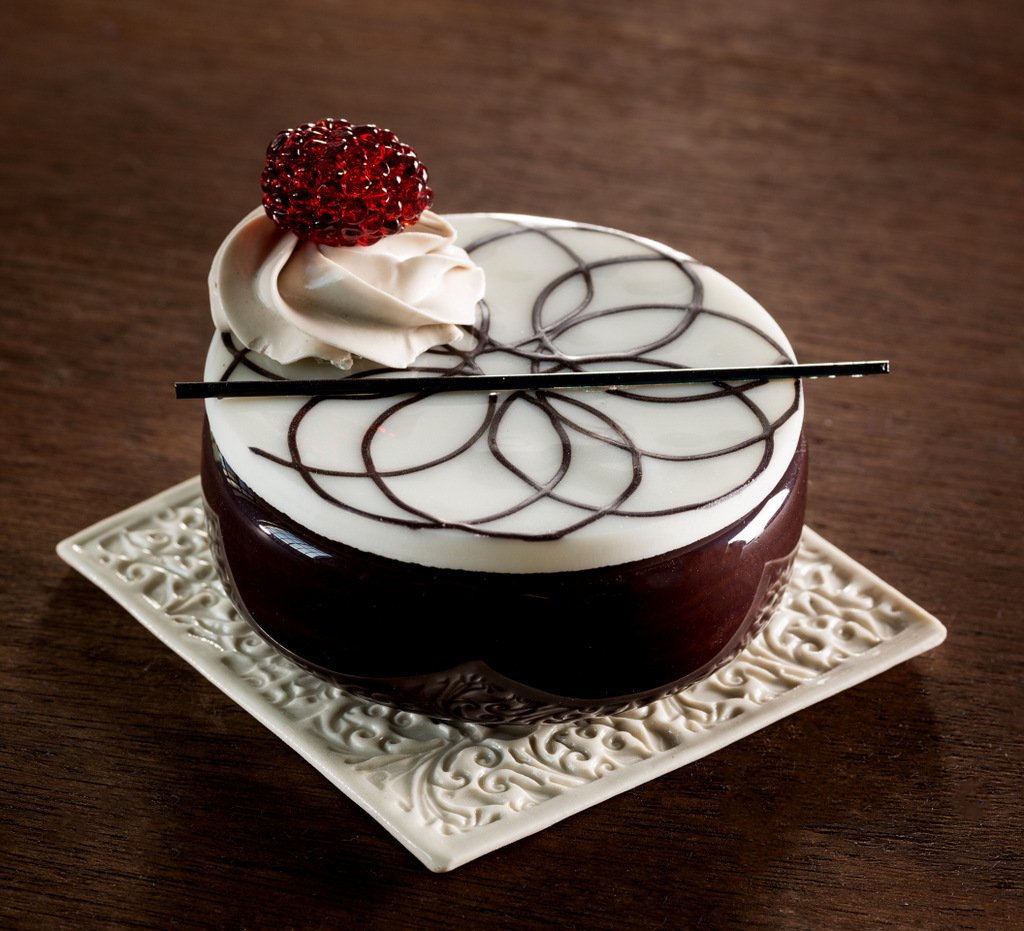 These beautiful cakes aren't real. They're actually made of glass by artist Shayna Leib.  http://shaynaleib.com/patisserie/ 