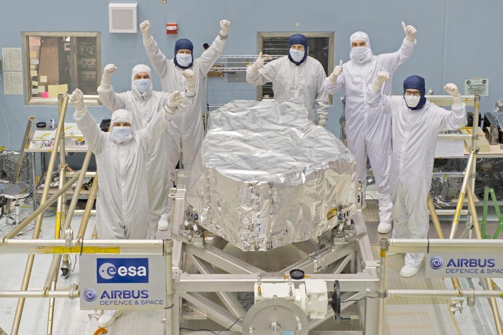 Part of the NIRSpec team cheers next to the instrument in its final configuration