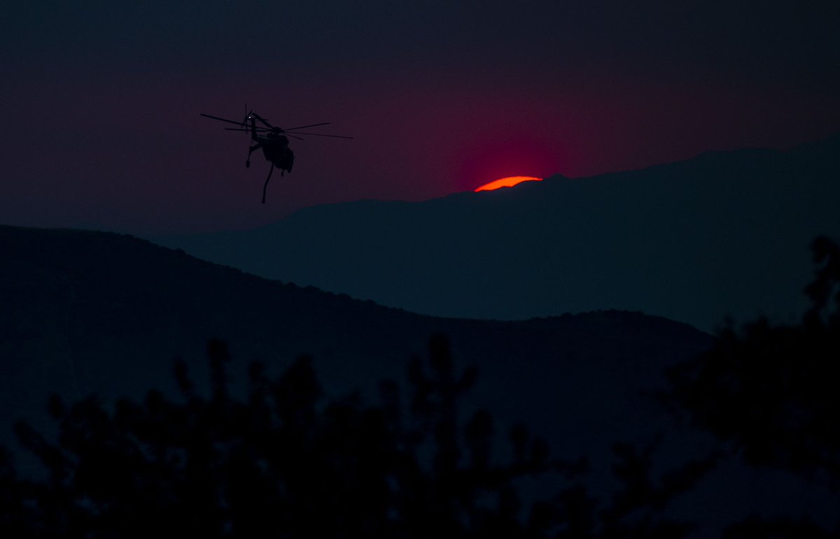 PE_Photo's tweet photo. A water dropping helicopter is silhouetted as it heads back to refill for another drop on the El Dorado Fire as the sun sets in the heavy smoke in Yucaipa on Sunday, September 6, 2020. (Photo by Terry Pierson, The Press-Enterprise/SCNG) https://t.co/UXwPDQvYmU