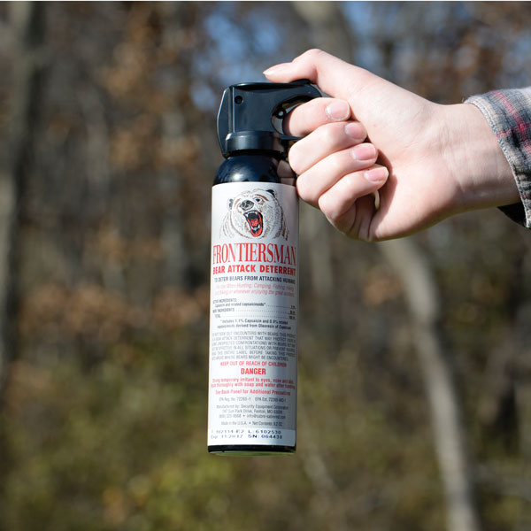 ADDENDUM TWO:Thanks to  @FrostyTakes can see what this is.Daniel repurposed a tourniquet pouch to hold an extra can of bear spray. He cut off the top flap.What looks like a gun is the extra can of bear spray. The harsh lighting leaves half the can in shadow.