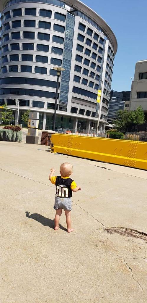 uiowa's tweet photo. This @UIChildrens NICU alumnus wasn't about to miss his chance to wave to the kids this weekend. 💛🖤 https://t.co/FcCSOYcAH1