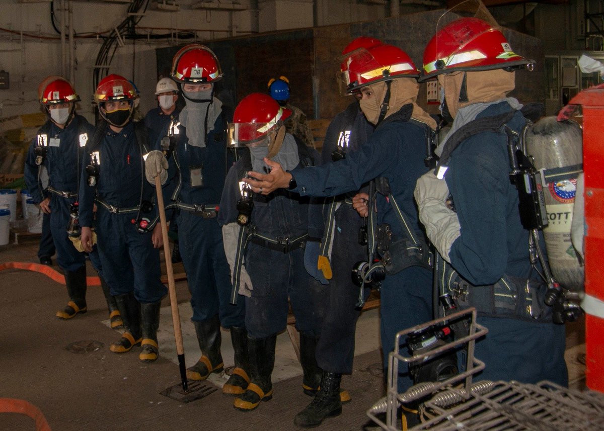 Members of the in-port emergency team aboard the Nimitz-class aircraft carrier USS George Washington (CVN 73) discuss ways to respond to an emergency during a fire drill. (U.S. Navy photo by Mass Communication Specialist 3rd Class Zack Thomas)