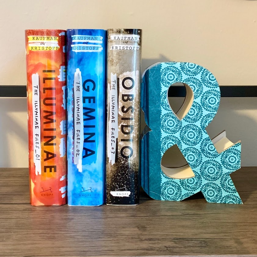EclecticReadPod's tweet photo. What's a series you’d like to finish this year? Meredith read Illuminae a couple of months ago &amp; picked up the other two books in the hopes of reading them by the end of the year. Also, happy National Ampersand Day! (Why is that a thing? Who knows 😂) #illuminae #tbr #scifi https://t.co/ZYyAKtL3pH