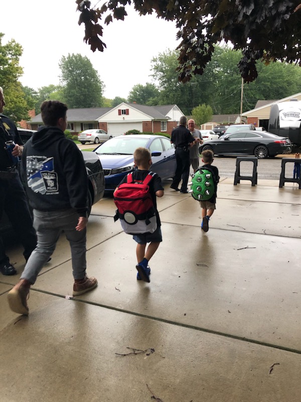 Toledo_PD's tweet photo. Today is the first day of school for Younes and Maytham Dia.  Rather than walk to school alone, dozens of Toledo Police officers came to make sure they got there safely. #toledopolice https://t.co/hkV42oC3v8