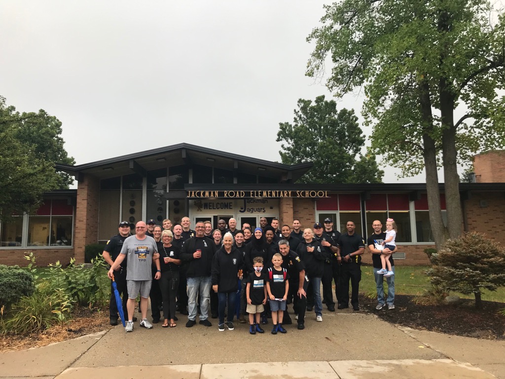 Toledo_PD's tweet photo. Today is the first day of school for Younes and Maytham Dia.  Rather than walk to school alone, dozens of Toledo Police officers came to make sure they got there safely. #toledopolice https://t.co/hkV42oC3v8