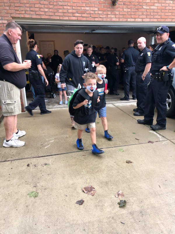 Toledo_PD's tweet photo. Today is the first day of school for Younes and Maytham Dia.  Rather than walk to school alone, dozens of Toledo Police officers came to make sure they got there safely. #toledopolice https://t.co/hkV42oC3v8