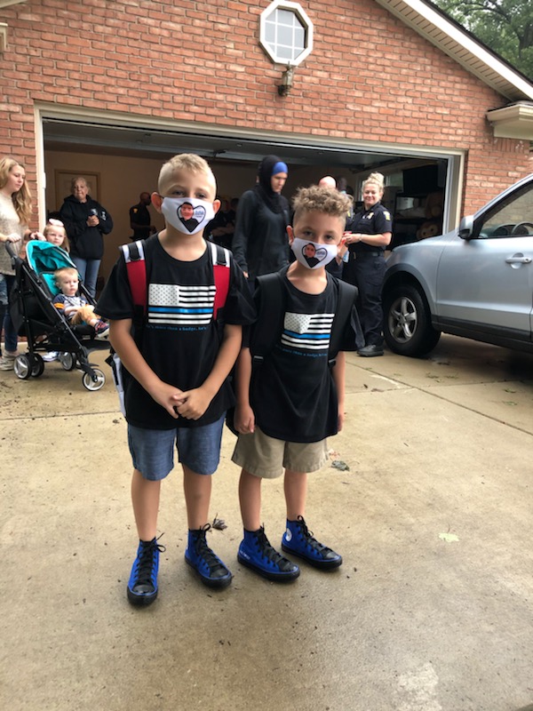 Toledo_PD's tweet photo. Today is the first day of school for Younes and Maytham Dia.  Rather than walk to school alone, dozens of Toledo Police officers came to make sure they got there safely. #toledopolice https://t.co/hkV42oC3v8