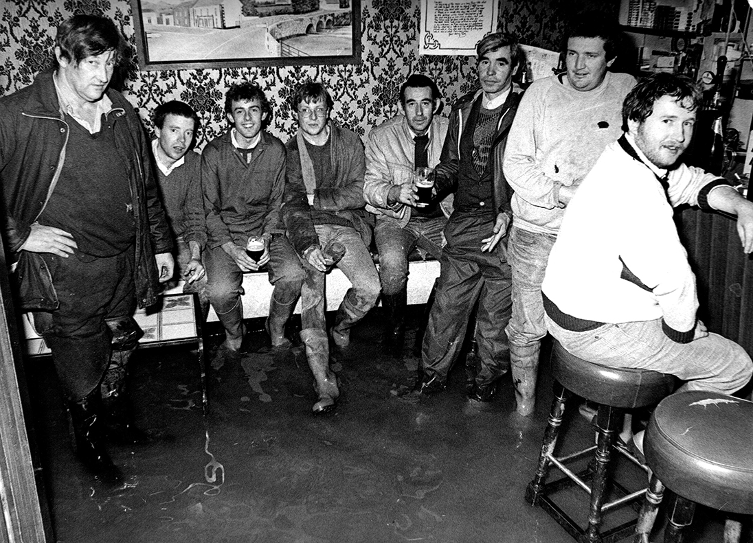 A real 'wet' pub. Locals in Peter Kenny's, Clonea-Power, Co #Waterford (now Clancy's Bar) still managed a pint despite the premises being flooded when the River Clodagh burst its banks after torrential rainfall in early November 1988. Photo by the late John Kiely, Kilmacthomas.