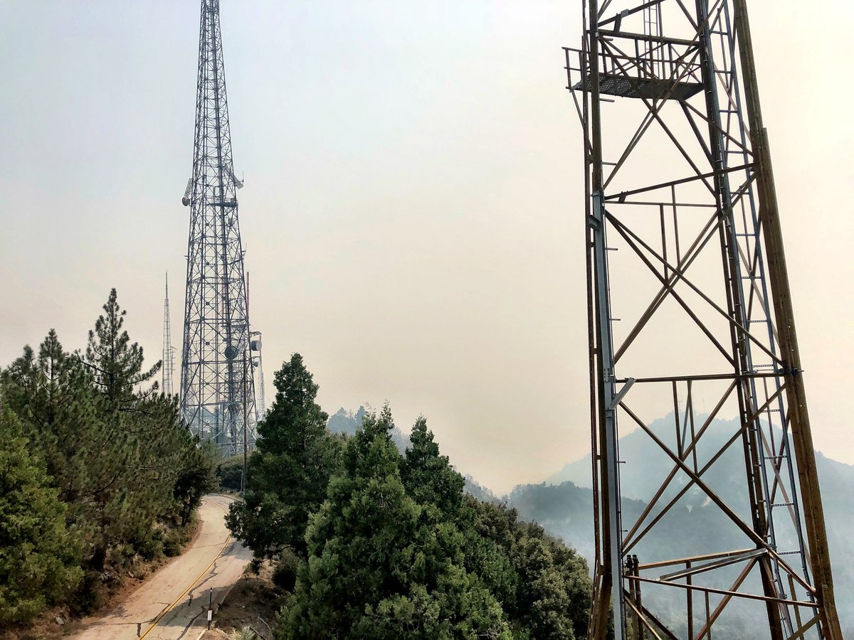 HarplaKPCC's tweet photo. @KPCC main transmitter site today at Mount Wilson. The #BobcatFire is on the East side of the compound and on the south at MountHarvard. Ground crews and dozers are doing an amazing job defending the observatory and the whole telecommunications farm. https://t.co/QkHHmSq8bN