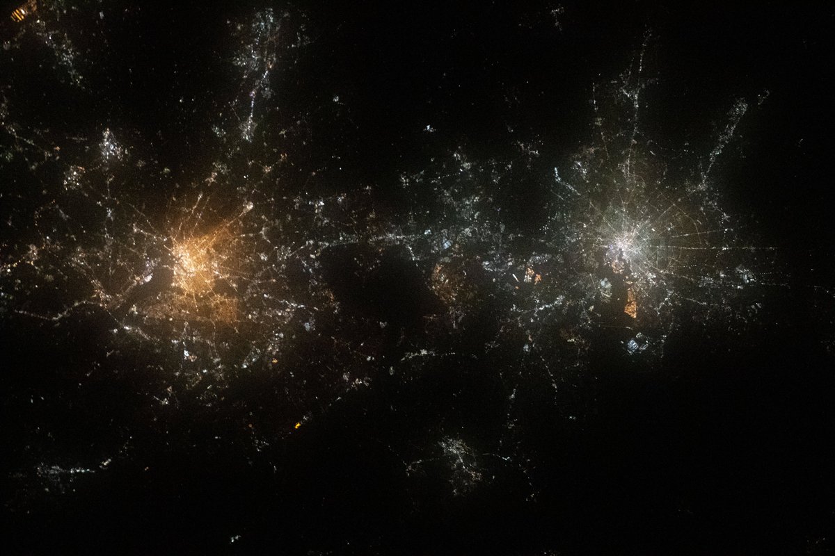 Space_Station's tweet image. Like two galaxies swirling near each other, Washington, D.C. (right) and Baltimore, Maryland, are pictured during a night pass from the station.