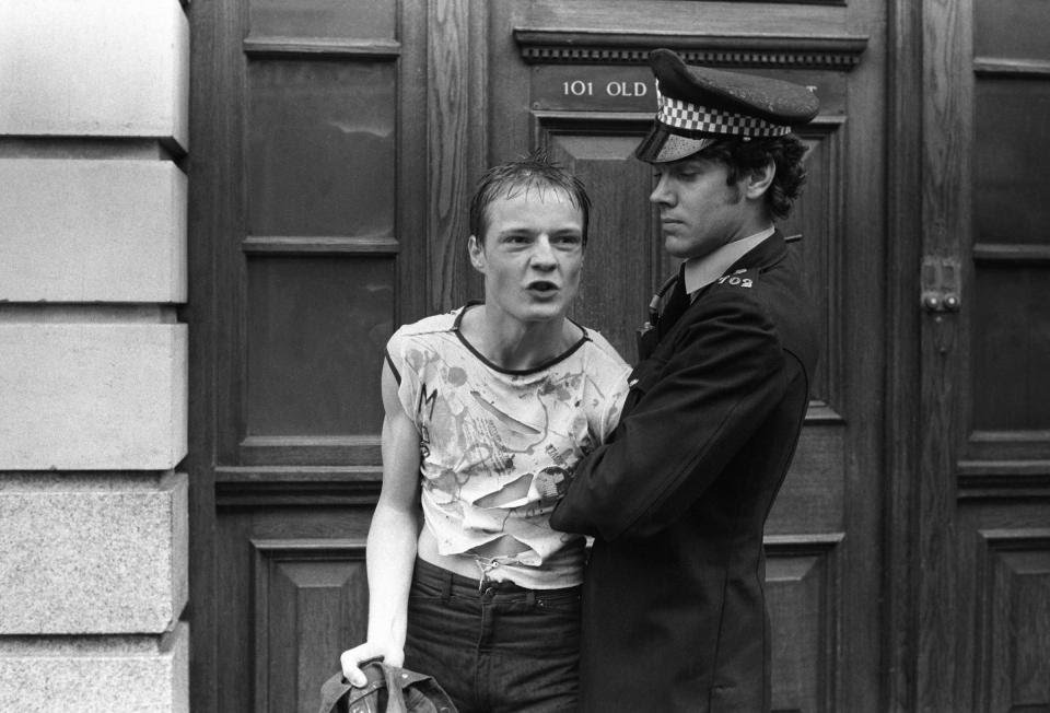 Chelsea, London, 1977.During the summer of 1977 Punks gathered each Saturday by the tube station in Sloane Square to walk down the King’s Road, handing out flowers and blocking the free flow of traffic. This guy is wearing a torn t-shirt from Smutz -  @HomerSykes