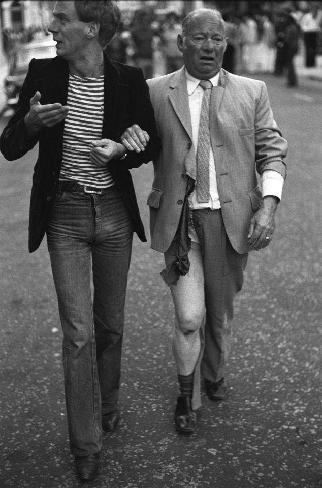 Notting Hill, London, 1977.A distraught couple targeted by homophobic youths; the older man had been attacked and his wallet stolen -  @HomerSykes