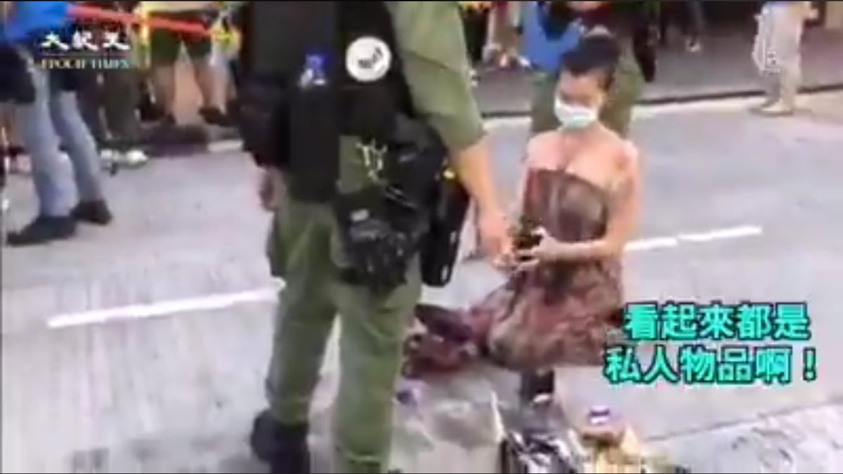 This is a THREAD on the lady kneeling and displaying all her things from her bag in front of a paramilitary green object. My comment on a previous post was that I believe it a good position to adopt, all things considered in HK at the moment. I want to explain more....