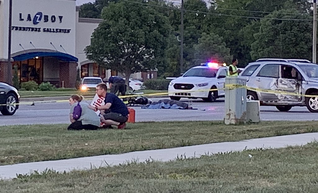 Fatal motorcycle crash on Southport Rd. just East of Emerson Ave., Indianapolis southeast side. Motorcycle rider survivor is comforted in foreground.
