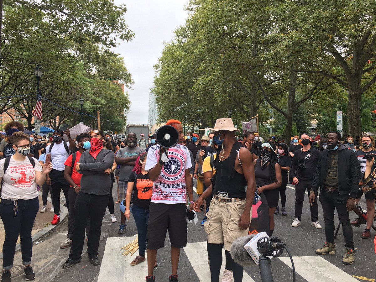 cjaramillo's tweet photo. City cancelled their press conference but encampment leaders are having their own. They argue the city is not doing enough and they won’t go away. Parkway traffic is blocked. Police cars are around but no officers close by. https://t.co/W0XSTZgBsc