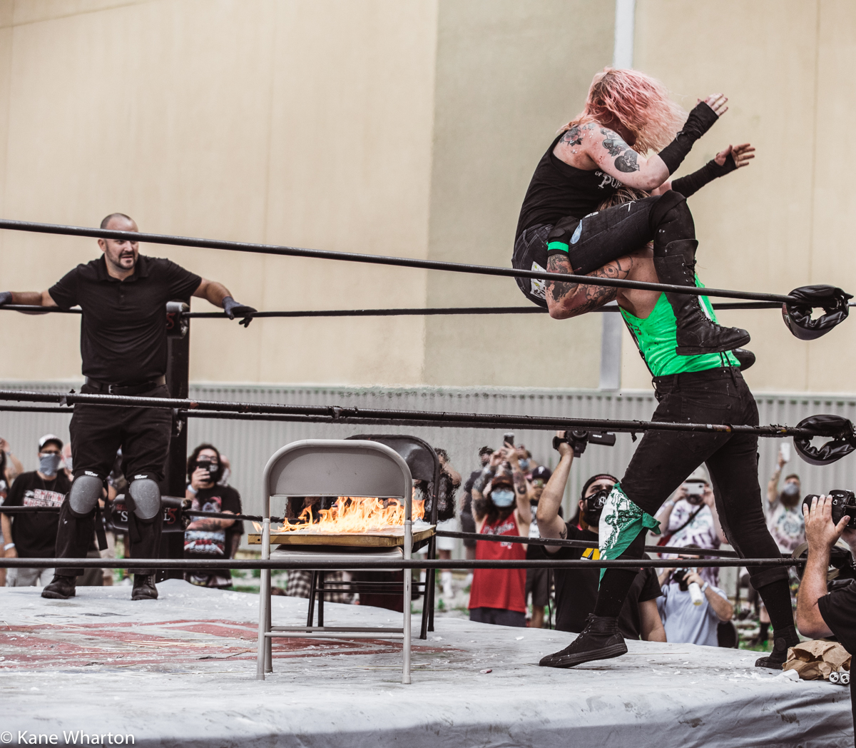 Kane_B13's tweet photo. In a 1st round match from #gcw #tournamentofsurvival 5 in Atlantic City, @Atticus_Cogar puts @meowdyxyall through a flaming table. #gcw #tournamentofsurvival #deathmatch #gcwtos5 https://t.co/RLJYAjmT2C
