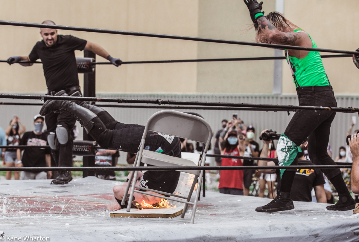 Kane_B13's tweet photo. In a 1st round match from #gcw #tournamentofsurvival 5 in Atlantic City, @Atticus_Cogar puts @meowdyxyall through a flaming table. #gcw #tournamentofsurvival #deathmatch #gcwtos5 https://t.co/RLJYAjmT2C