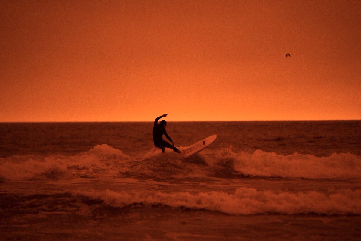 bethlaberge's tweet photo. Surfers at Ocean Beach in San Francisco today around noon under an #orangesky due to smoke from wildfires in Northern California and Oregon. @KQEDnews 

#BayAreaFires #Surfing #OceanBeach https://t.co/NMqM2wNae7