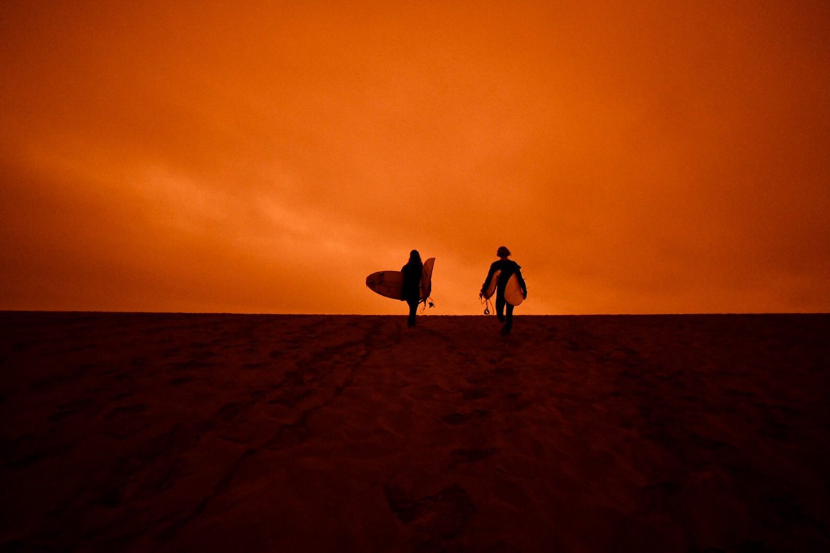 bethlaberge's tweet photo. Surfers at Ocean Beach in San Francisco today around noon under an #orangesky due to smoke from wildfires in Northern California and Oregon. @KQEDnews 

#BayAreaFires #Surfing #OceanBeach https://t.co/NMqM2wNae7