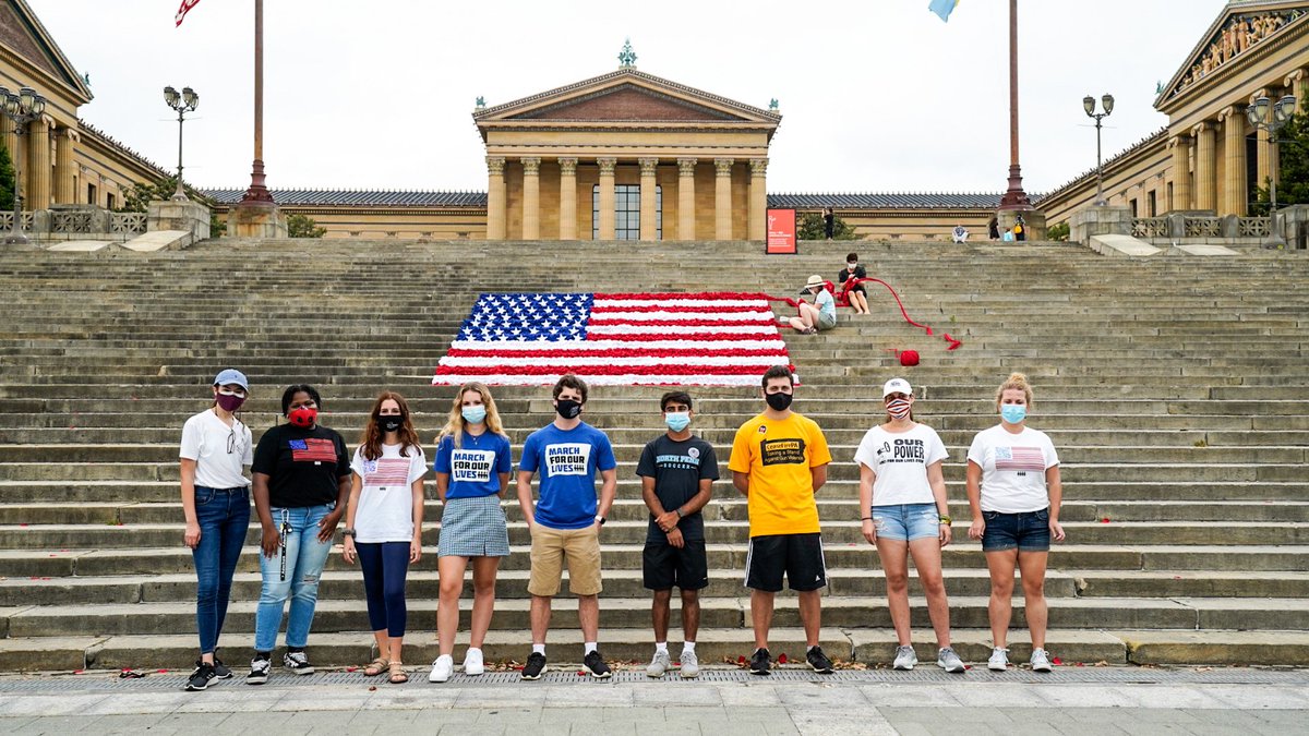 March4Philly's tweet photo. Today we registered voters and participated in an art installation addressing gun violence and poverty in America. @mmhaims_ created the American flag behind us unraveling to spell out “End Gun Violence”. 

#OurPower #VoteForOurLives 
📸: Dylan Eddinger https://t.co/ln4uHoEkyR