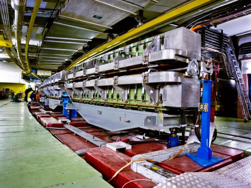 4) The protons come out of the booster and into the Proton Synchrotron (PS), a 628 metre long ring consisting of 277 conventional (room-temperature) electromagnets! It accelerates the protons to 25 GeV. https://home.cern/science/accelerators/proton-synchrotron