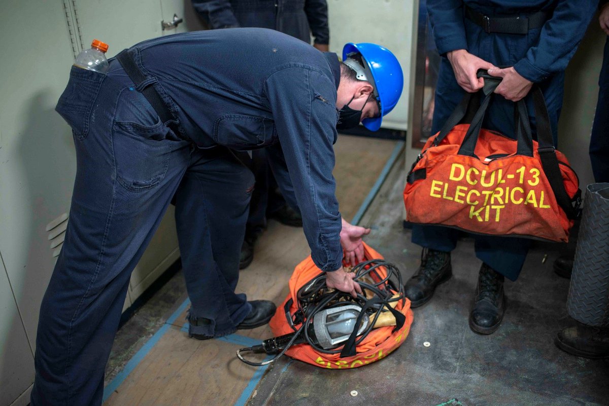 Electrician’s Mate 3rd Class Robert Johnson, a Sailor assigned to the engineering department aboard the Nimitz-class aircraft carrier USS George Washington (CVN 73), stows gear used to investigate and fight an electrical fire during a drill. (U.S. Navy photo by MC2 Marlan Sawyer)