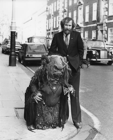 hearthspell's tweet photo. Director and puppeteer Jim Henson standing on a street corner with Aughra, a character from his 1982 film "The Dark Crystal." https://t.co/bGZI0r2zyF