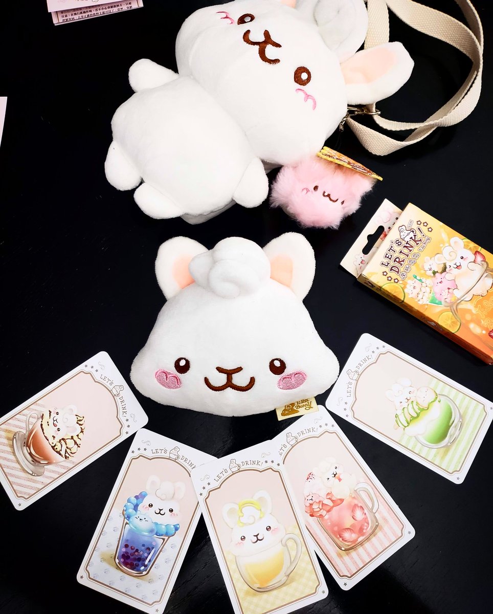 BoardGameGeek's tweet photo. Let's Drink! One of the most adorable games out there! Here are two editions. The cards on display are from the new edition in the bigger bunny purse. Real-time pattern game from @MoziGames. Really fun! - Steph @BoardGamerSteph #bgg #newgames #spiel19 #letsdrink #mozigames https://t.co/abSXg8saDi