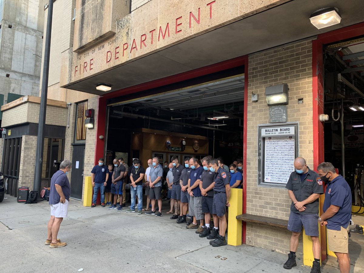 FDNY's tweet photo. FDNY members at #Engine53 and #Ladder43 observe a moment of silence at 0903, the moment the second plane struck the South Tower #NeverForget https://t.co/kzXXsvIlLx