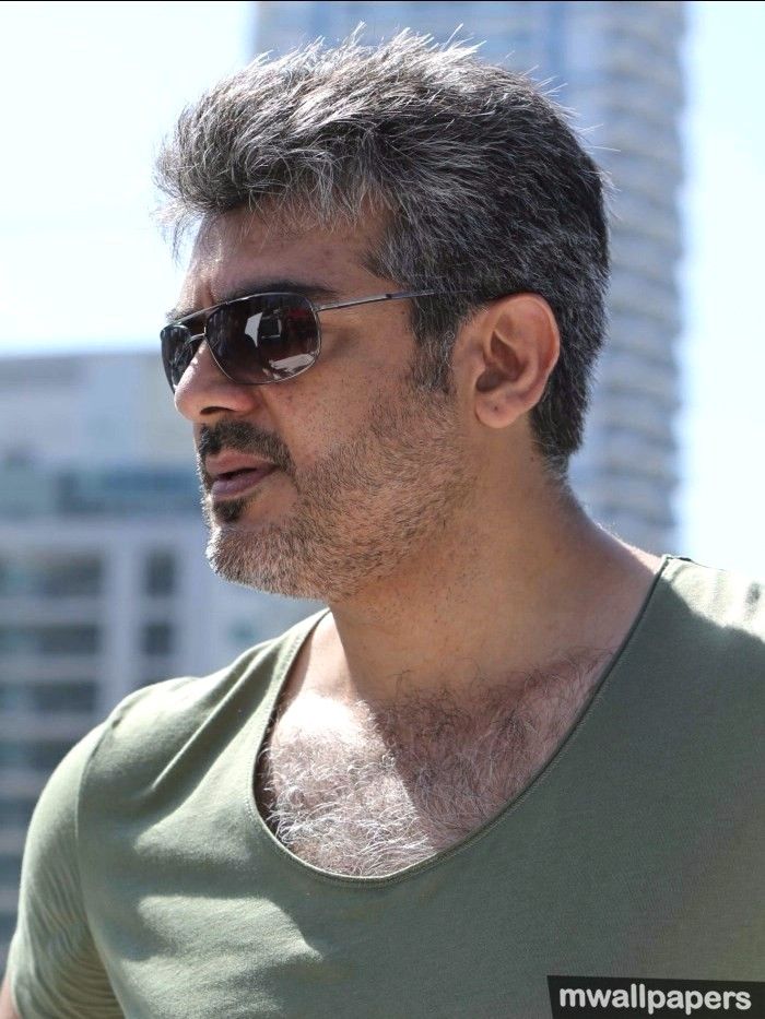 Download Captivating Stare: Ajith Kumar in a White Polo HD Photo Wallpaper  | Wallpapers.com