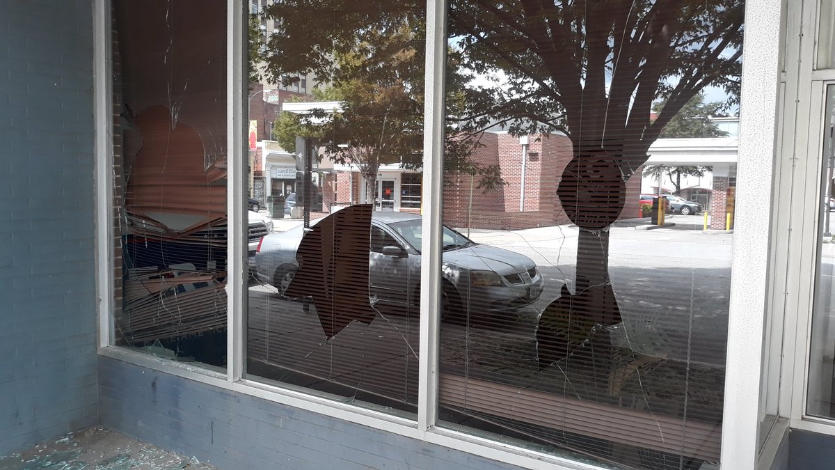 3 more windows are broken. A large Trump sign is visible. As you can tell, a bank is across the street with cameras that could see the suspects. A person who works nearby tells me that a dog usually stays in the office overnight, they weren't sure if the dog got out.