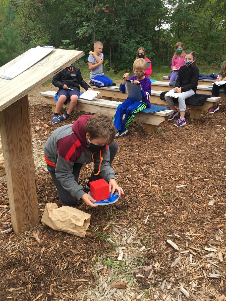 pollardclass477's tweet photo. Math class-place value lesson  today outside on the school forest benches. https://t.co/sTLhri7Mci