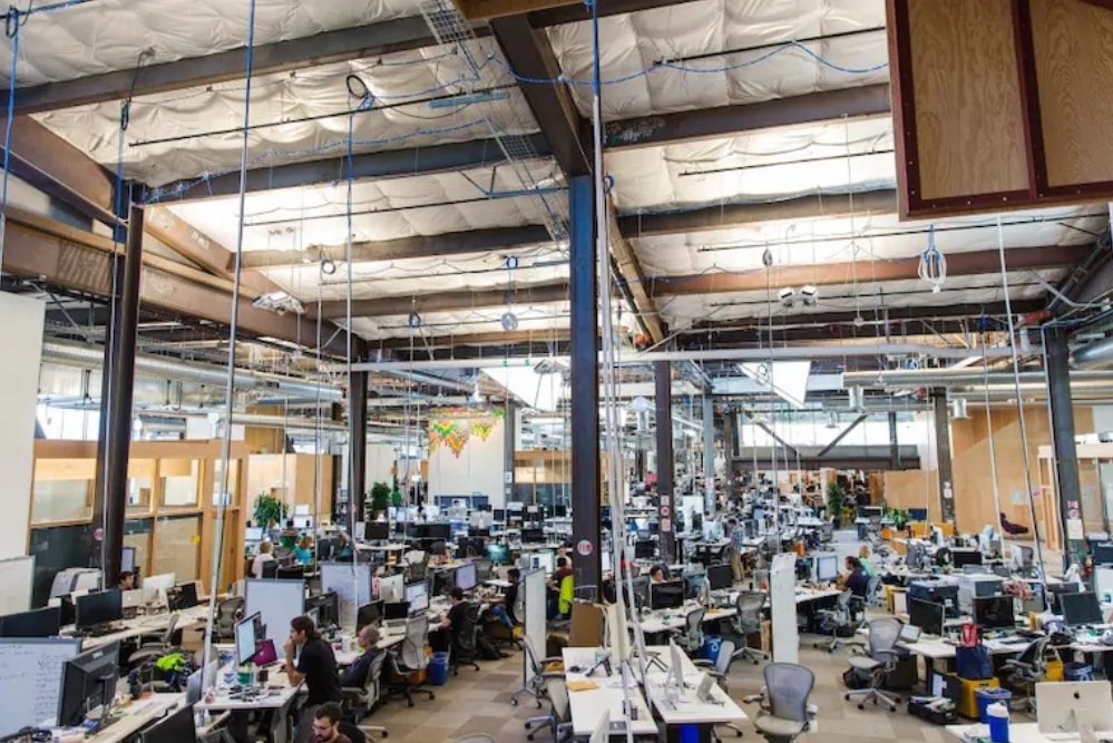 Digging into things, here's what I was able to suss out: In 2015 Facebook opened "MK 20", 433,555 square feet of bullpen. Desks crammed cheek by jowl. The nightmarish apotheosis of everything anti-human about the open plan office. https://www.washingtonpost.com/news/the-switch/wp/2015/11/30/what-these-photos-of-facebooks-new-headquarters-say-about-the-future-of-work/
