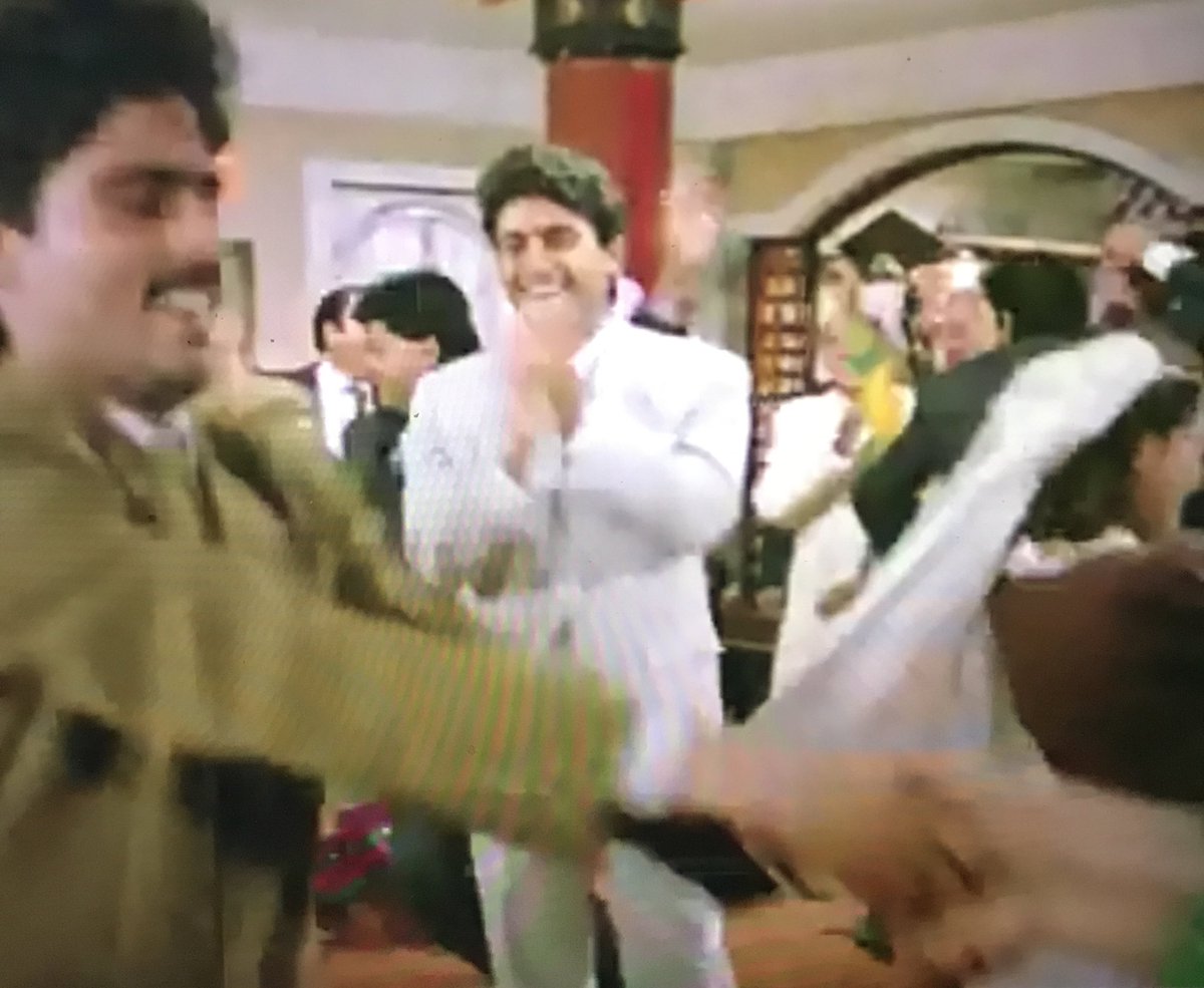 Everyone dancing. Rajesh clapping hands thinking when the F can I get out of this damn set and movie?
