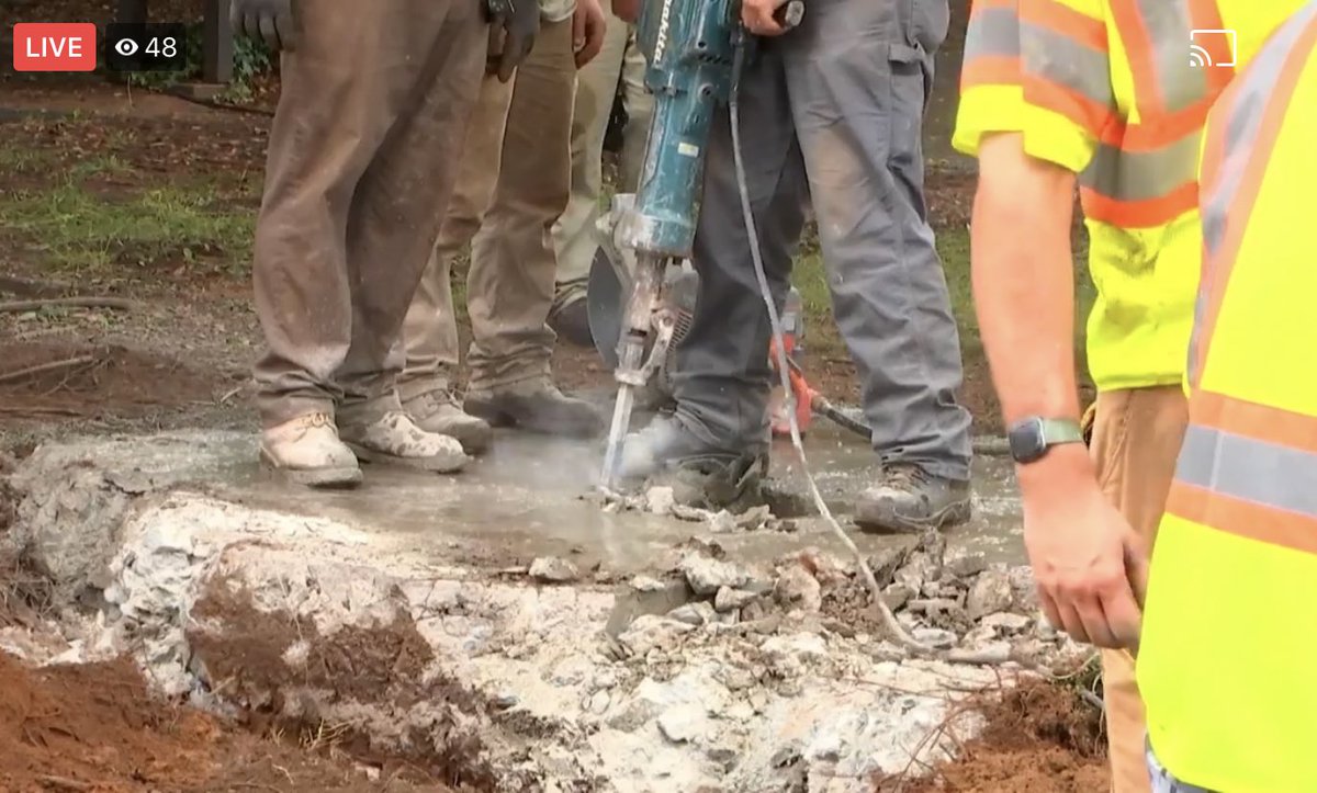 a still from the county’s livestream - it looks like they are now carefully jackhammering around the rim of the hole where the time capsule is. the box fits too tightly in the hole to be lifted out without damaging it, which would get its contents wet, destroying them.