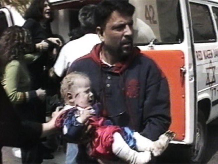 On March 21, ‘97, a Palestinian suicide bomber blew himself up in a café in Tel Aviv. 3 young women, including the mother of this baby, were killed. On July 30, 2 Palestinians blew themselves up in the Mahane Yehuda Market in Jerusalem, killing 16 >>