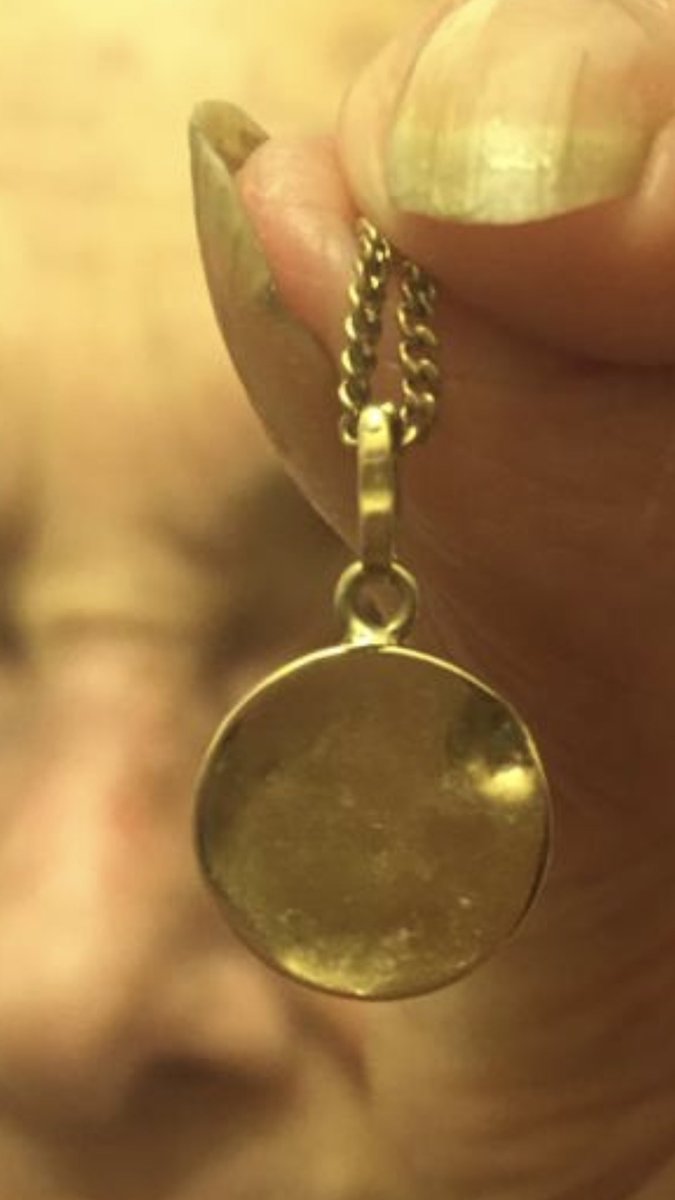 The pendant went with them & survived.She has worn the pendant every day since, in memory of her murdered family.(You can see the dent in the pendant from where it was nailed in to the shoe in the photo.)