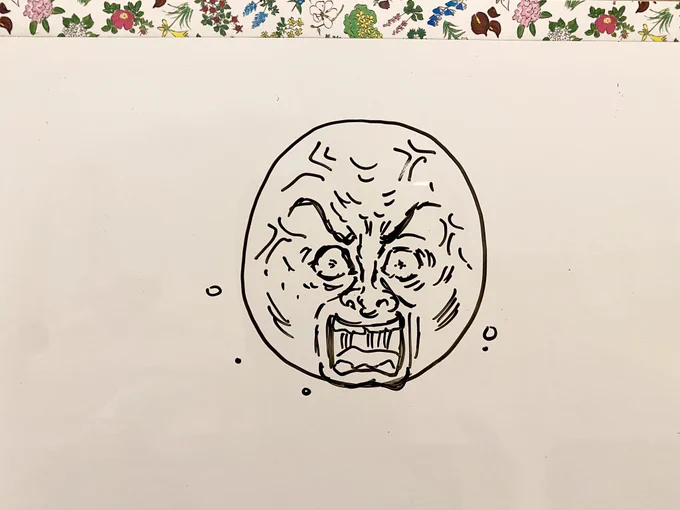夫がホワイトボードに円を描いて「怒った顔ってどう描く?」と聞いてきたので描いた。 