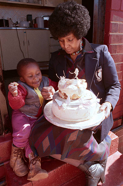 As I said earlier, the Mandelas couldn't finish their celebrations they couldn't even enjoy their wedding cake. But uZami kept it. She would take it out on their anniversary every year as she awaited his return. This was taken nearly 20 years after her wedding.: David Turnley